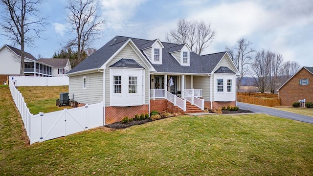 view of front of house with covered porch, a fenced backyard, a front lawn, and a gate