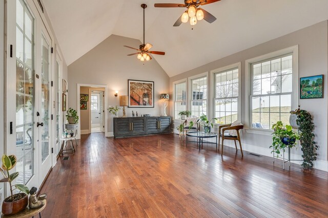 living area with visible vents, high vaulted ceiling, baseboards, and wood-type flooring