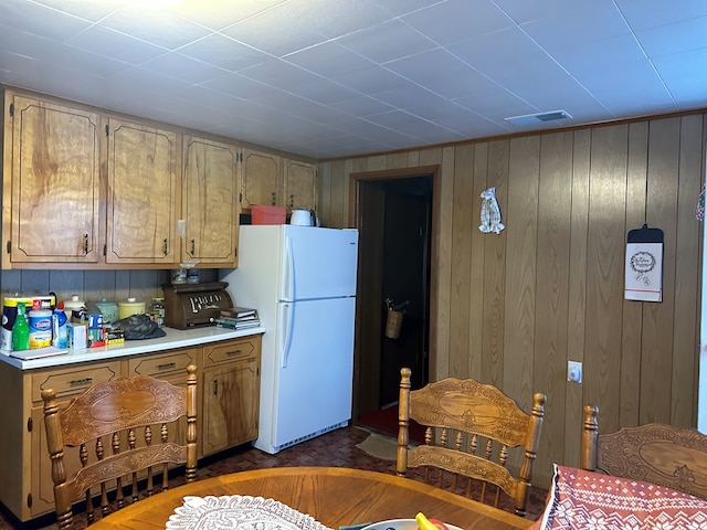 4860 Greasy Creek Rd, Bandy, VA 24602 - kitchen featuring freestanding refrigerator, light countertops, and wooden walls
