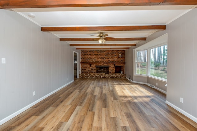 15743 Monticello Dr, Bristol, VA 24202 - unfurnished living room featuring wood finished floors, a fireplace, beam ceiling, a ceiling fan, and baseboards