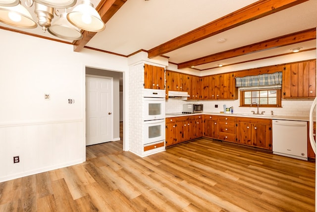 15743 Monticello Dr, Bristol, VA 24202 - kitchen with white appliances, a sink, under cabinet range hood, brown cabinets, and beamed ceiling