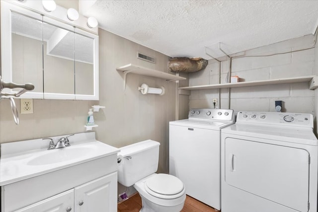 542 Mosswood Ln, Bristol, VA 24201 - bathroom with independent washer and dryer, a textured ceiling, wood finished floors, toilet, and vanity