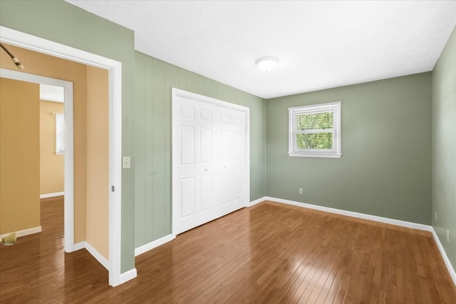 542 Mosswood Ln, Bristol, VA 24201 - unfurnished bedroom featuring hardwood / wood-style floors, baseboards, and a closet
