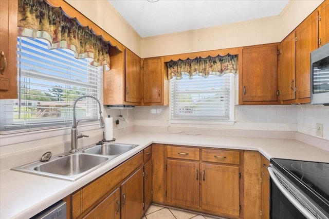 542 Mosswood Ln, Bristol, VA 24201 - kitchen featuring a sink, brown cabinetry, decorative backsplash, and stainless steel appliances