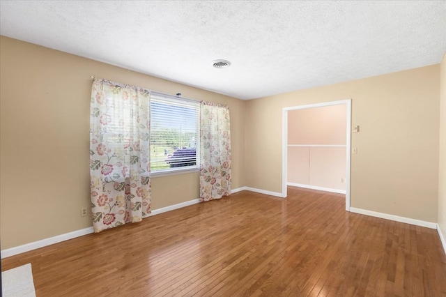 542 Mosswood Ln, Bristol, VA 24201 - spare room featuring wood-type flooring, baseboards, and a textured ceiling