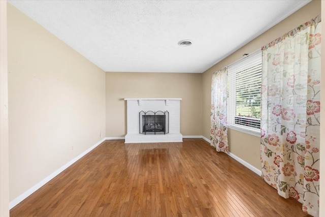 542 Mosswood Ln, Bristol, VA 24201 - unfurnished living room featuring hardwood / wood-style flooring, baseboards, and a fireplace