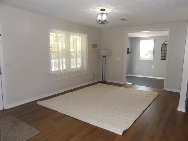 entryway featuring dark hardwood / wood-style flooring and a notable chandelier