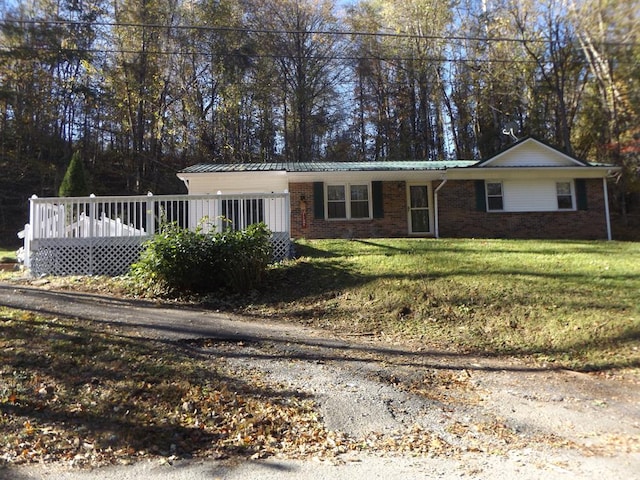 ranch-style house with a front lawn and a deck