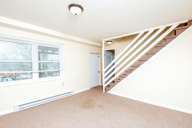 interior space with a baseboard radiator, carpet, baseboards, and stairs