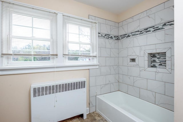 full bathroom featuring radiator heating unit and shower / washtub combination