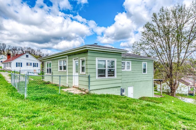 view of property exterior with a yard and fence