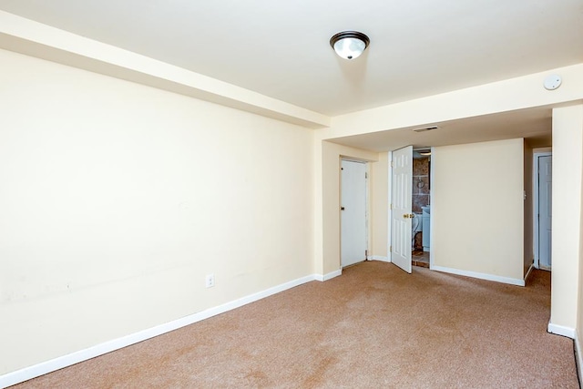spare room featuring baseboards, carpet flooring, and visible vents