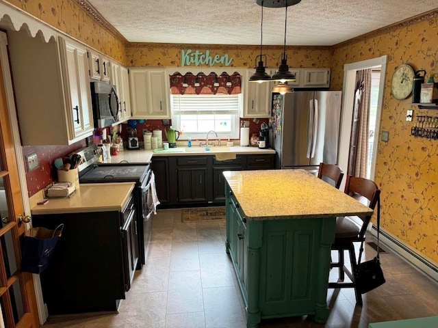 kitchen with appliances with stainless steel finishes, a textured ceiling, light countertops, and wallpapered walls