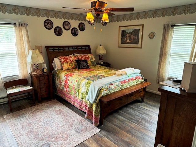bedroom featuring a ceiling fan, multiple windows, and wood finished floors