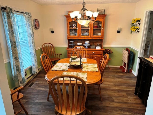 dining area with visible vents, baseboard heating, baseboards, dark wood-style flooring, and a notable chandelier