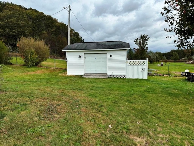 view of outbuilding with fence and an outdoor structure