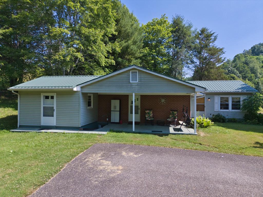3456 Dugspur Rd, Dugspur, VA 24325 - ranch-style house featuring a front yard, a metal roof, and brick siding