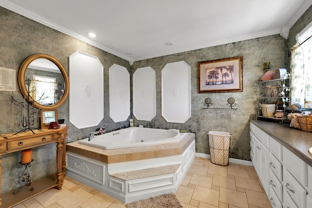 bathroom featuring tile patterned flooring, vanity, crown molding, and a tub