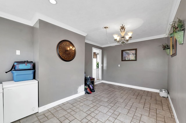 foyer with ornamental molding and an inviting chandelier