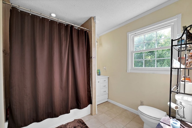 full bathroom with shower / tub combo with curtain, vanity, toilet, tile patterned floors, and a textured ceiling