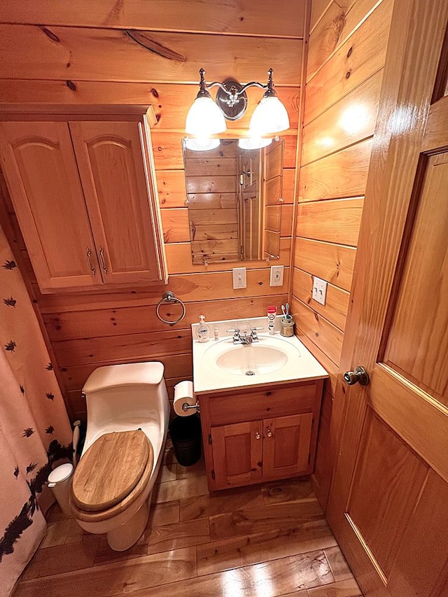 805 Double Bridges Dr, Fancy Gap, VA 24328 - bathroom with wooden walls, vanity, and wood-type flooring