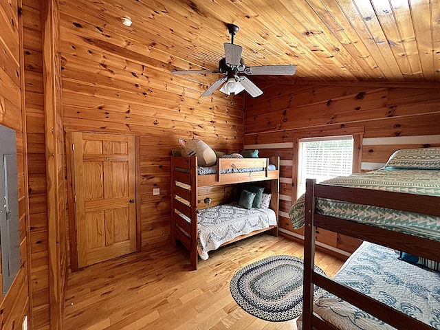 805 Double Bridges Dr, Fancy Gap, VA 24328 - bedroom with wood ceiling, light wood-type flooring, vaulted ceiling, wood walls, and a ceiling fan