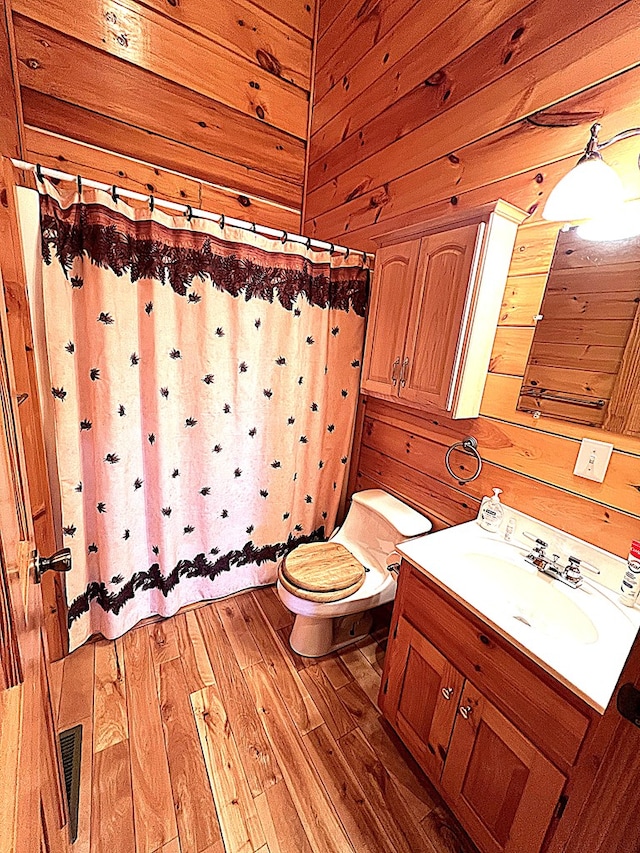 805 Double Bridges Dr, Fancy Gap, VA 24328 - bathroom with wood walls, vanity, wood finished floors, and a shower with curtain