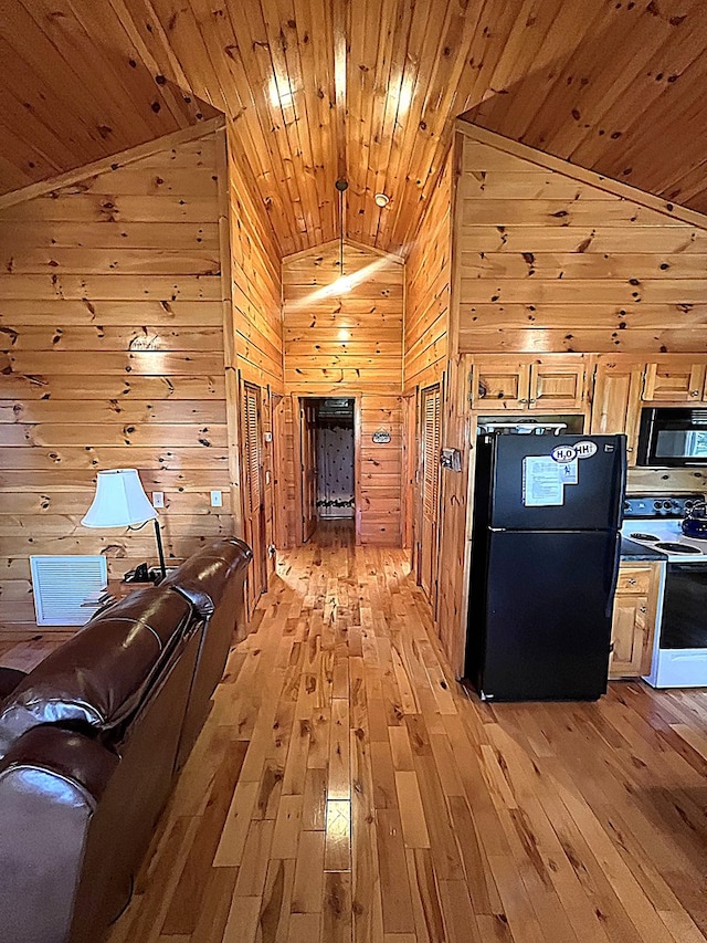 805 Double Bridges Dr, Fancy Gap, VA 24328 - kitchen with black appliances, vaulted ceiling, light wood finished floors, wood walls, and wooden ceiling