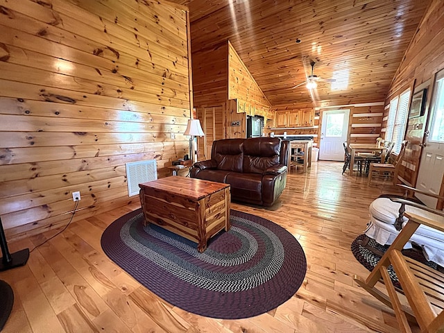 805 Double Bridges Dr, Fancy Gap, VA 24328 - living area featuring lofted ceiling, light wood finished floors, wood walls, ceiling fan, and wooden ceiling