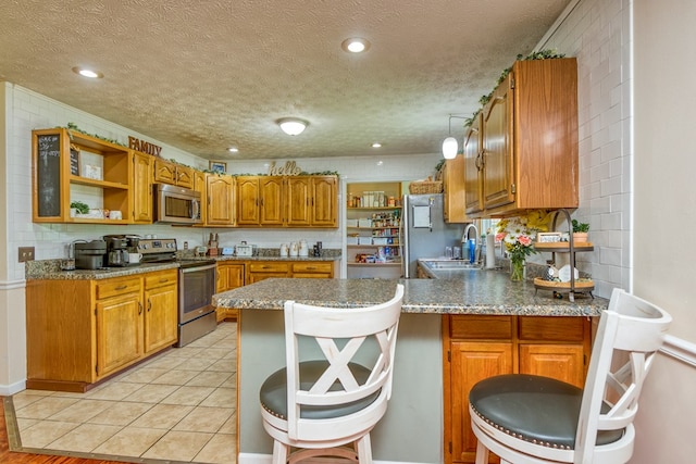 556 Stoney Battery Rd, Marion, VA 24354 - kitchen with appliances with stainless steel finishes, a peninsula, open shelves, brown cabinetry, and a sink