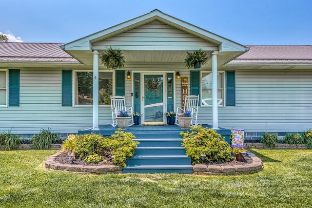 556 Stoney Battery Rd, Marion, VA 24354 - view of exterior entry with crawl space, a yard, metal roof, and covered porch