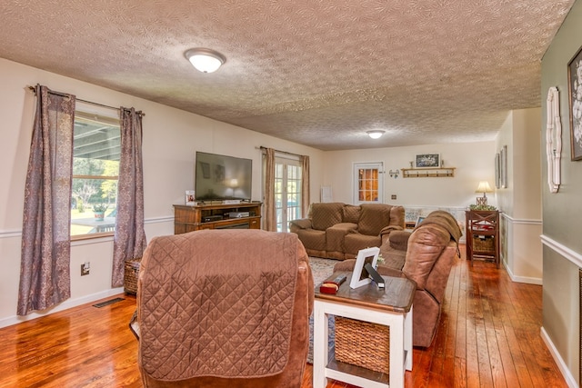556 Stoney Battery Rd, Marion, VA 24354 - living area with hardwood / wood-style floors, a textured ceiling, and baseboards