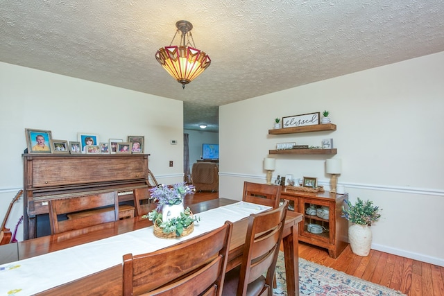 556 Stoney Battery Rd, Marion, VA 24354 - dining space featuring light wood-style flooring, a textured ceiling, and baseboards