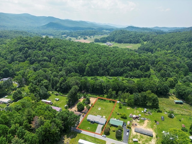 556 Stoney Battery Rd, Marion, VA 24354 - aerial view of property and surrounding area featuring property parcel outlined, a heavily wooded area, and a mountainous background