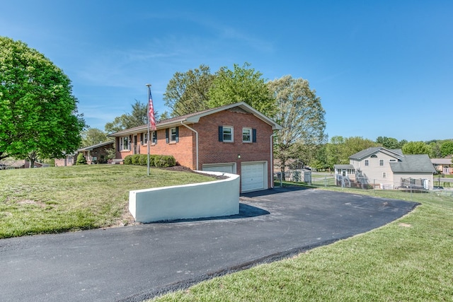 515 Meadowcrest Dr, Bristol, VA 24201 - view of front of house featuring fence, an attached garage, brick siding, aphalt driveway, and a front yard