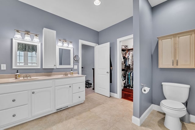 567 Saint James Rd, Chilhowie, VA 24319 - full bath featuring double vanity, tile patterned flooring, baseboards, toilet, and a walk in closet