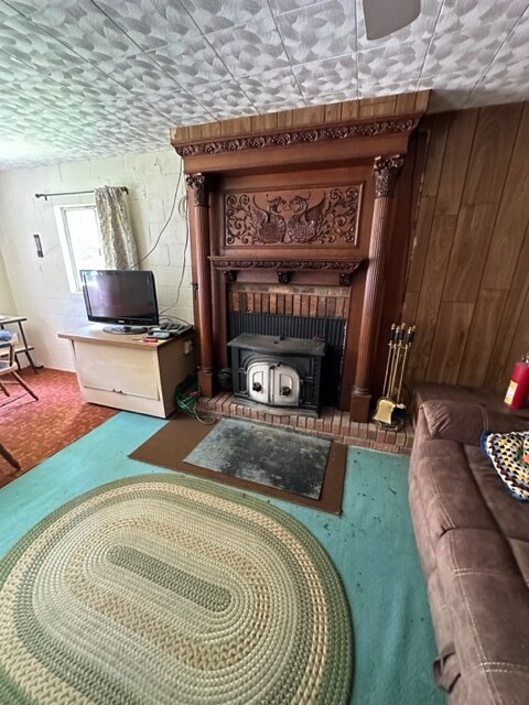 TBD Blue Springs Rd, Elk Creek, VA 24326 - living area with a wood stove and wooden walls