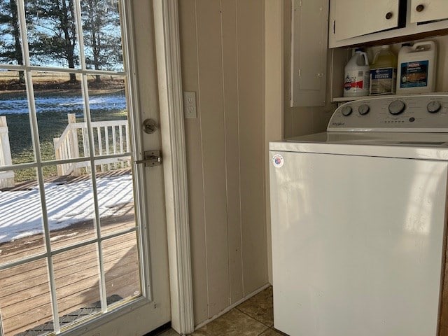 laundry room featuring cabinets, plenty of natural light, and washer / dryer