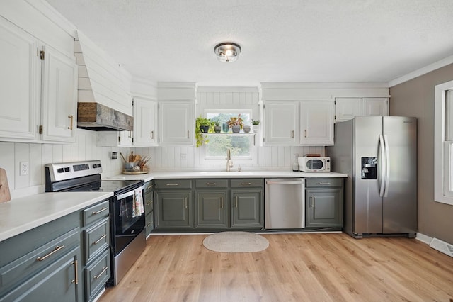 16050 Industrial Park Rd, Bristol, VA 24202 - kitchen featuring appliances with stainless steel finishes, custom exhaust hood, gray cabinets, white cabinets, and crown molding