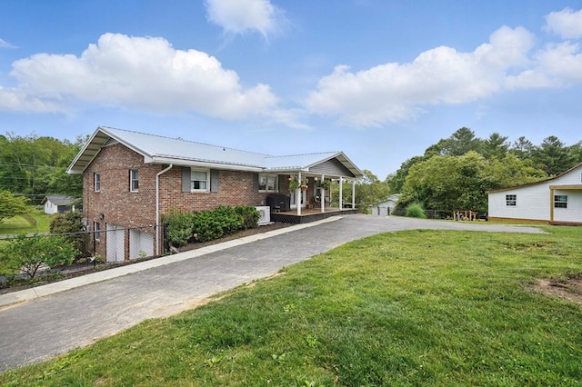 16050 Industrial Park Rd, Bristol, VA 24202 - ranch-style house featuring covered porch, driveway, brick siding, a metal roof, and an attached garage