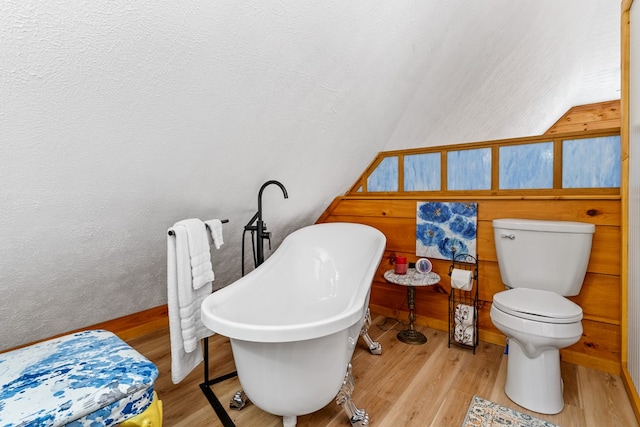 799 Crystal Springs Dr, Fancy Gap, VA 24328 - bathroom featuring wood finished floors, a freestanding tub, toilet, and baseboards