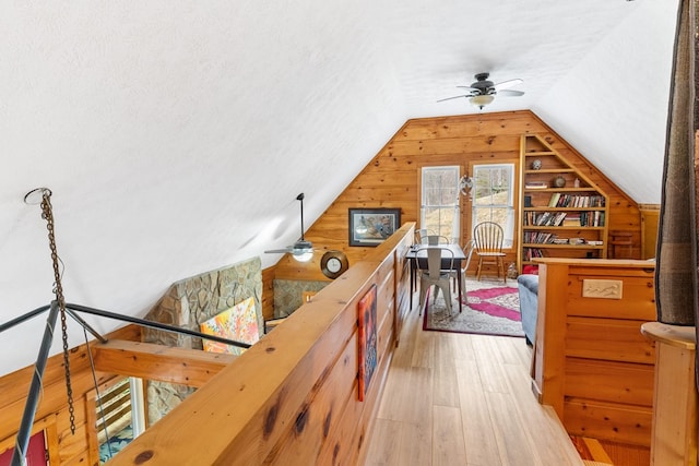 799 Crystal Springs Dr, Fancy Gap, VA 24328 - hallway with hardwood / wood-style flooring, vaulted ceiling, wood walls, and a textured ceiling