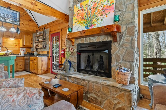 799 Crystal Springs Dr, Fancy Gap, VA 24328 - living area with light wood-style floors, a fireplace, and wooden walls