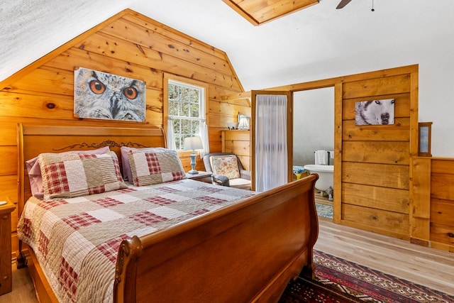 799 Crystal Springs Dr, Fancy Gap, VA 24328 - bedroom with wood finished floors, vaulted ceiling, wooden walls, and ceiling fan
