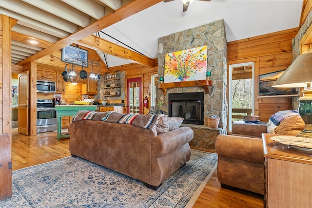 799 Crystal Springs Dr, Fancy Gap, VA 24328 - living area with wooden walls, healthy amount of natural light, light wood-style floors, a ceiling fan, and a fireplace