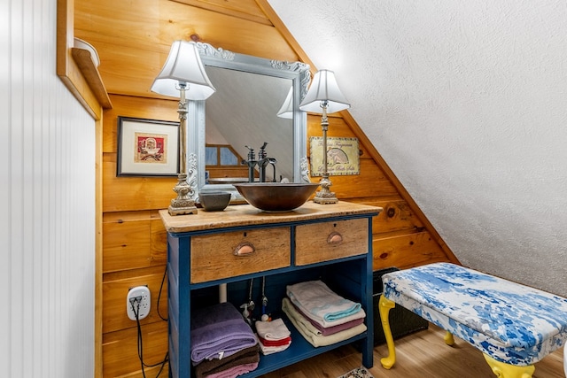 799 Crystal Springs Dr, Fancy Gap, VA 24328 - bedroom with a sink, wood finished floors, vaulted ceiling, and wooden walls