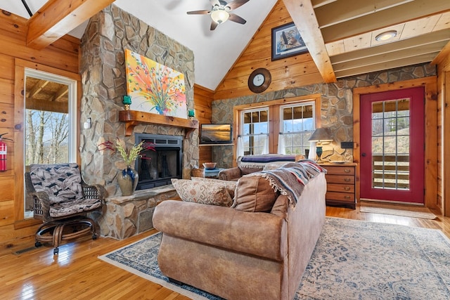 799 Crystal Springs Dr, Fancy Gap, VA 24328 - living area with hardwood / wood-style floors, high vaulted ceiling, ceiling fan, a stone fireplace, and wooden walls