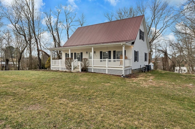 view of front of house with a front yard, cooling unit, a porch, crawl space, and metal roof