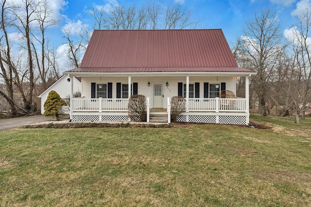 farmhouse inspired home with covered porch, metal roof, and a front yard