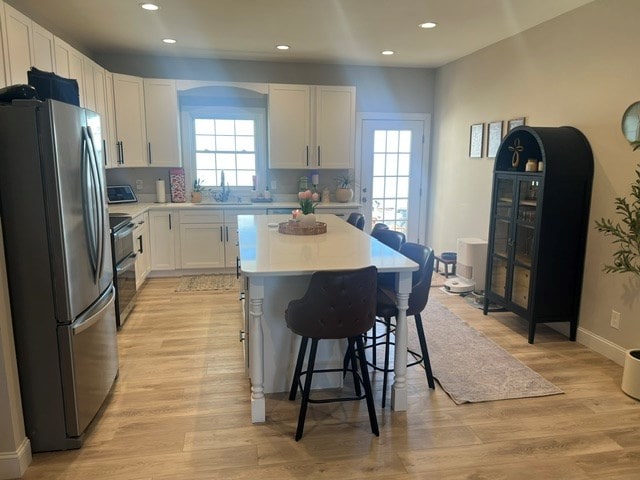 679 Hillman Hwy, Glade Spring, VA 24340 - kitchen featuring freestanding refrigerator, range with two ovens, a kitchen bar, a kitchen island, and recessed lighting